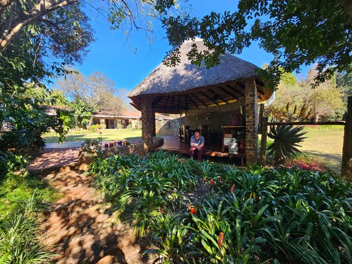The thatched lapa seen down the garden path between the bromeliads at Craffenheim Rottweilers